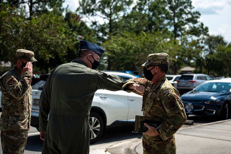 Photo of commanders greeting each other.