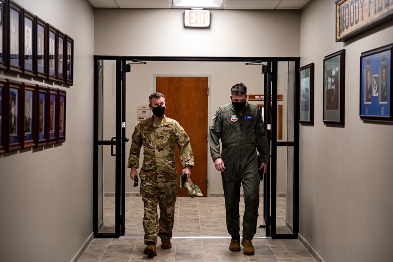 Photo of commanders walking and talking.