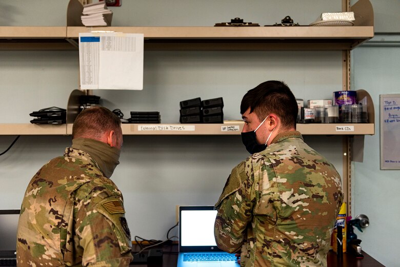 Photo of Airman speaking with command chief.