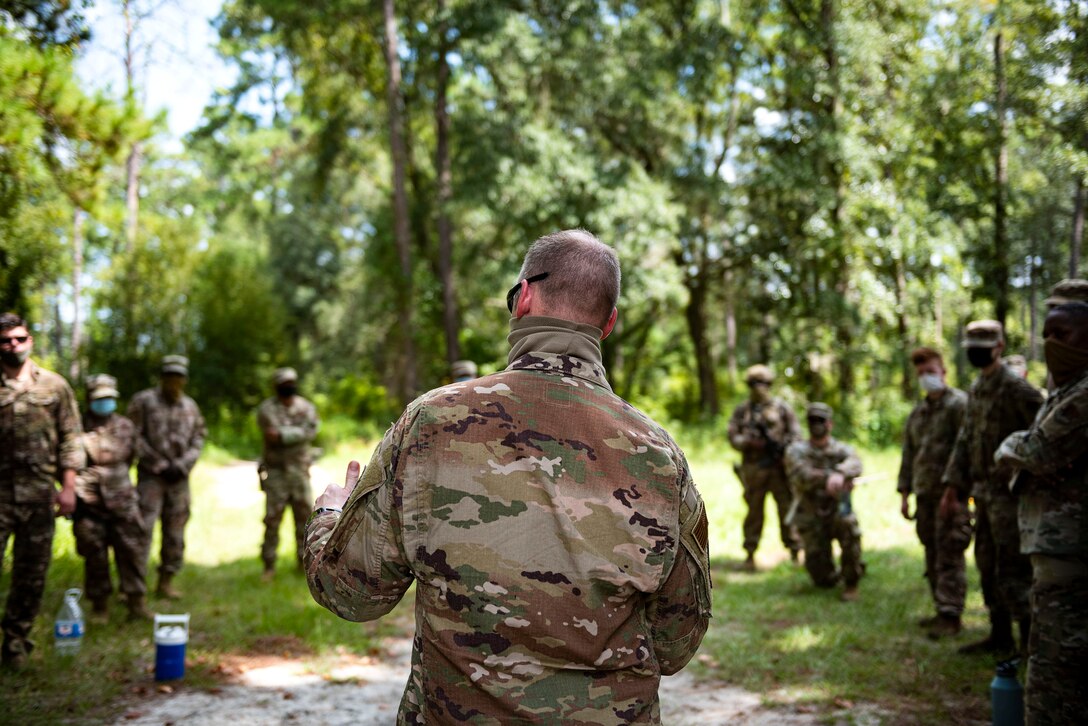 Photo of command chief speaking with Airmen.