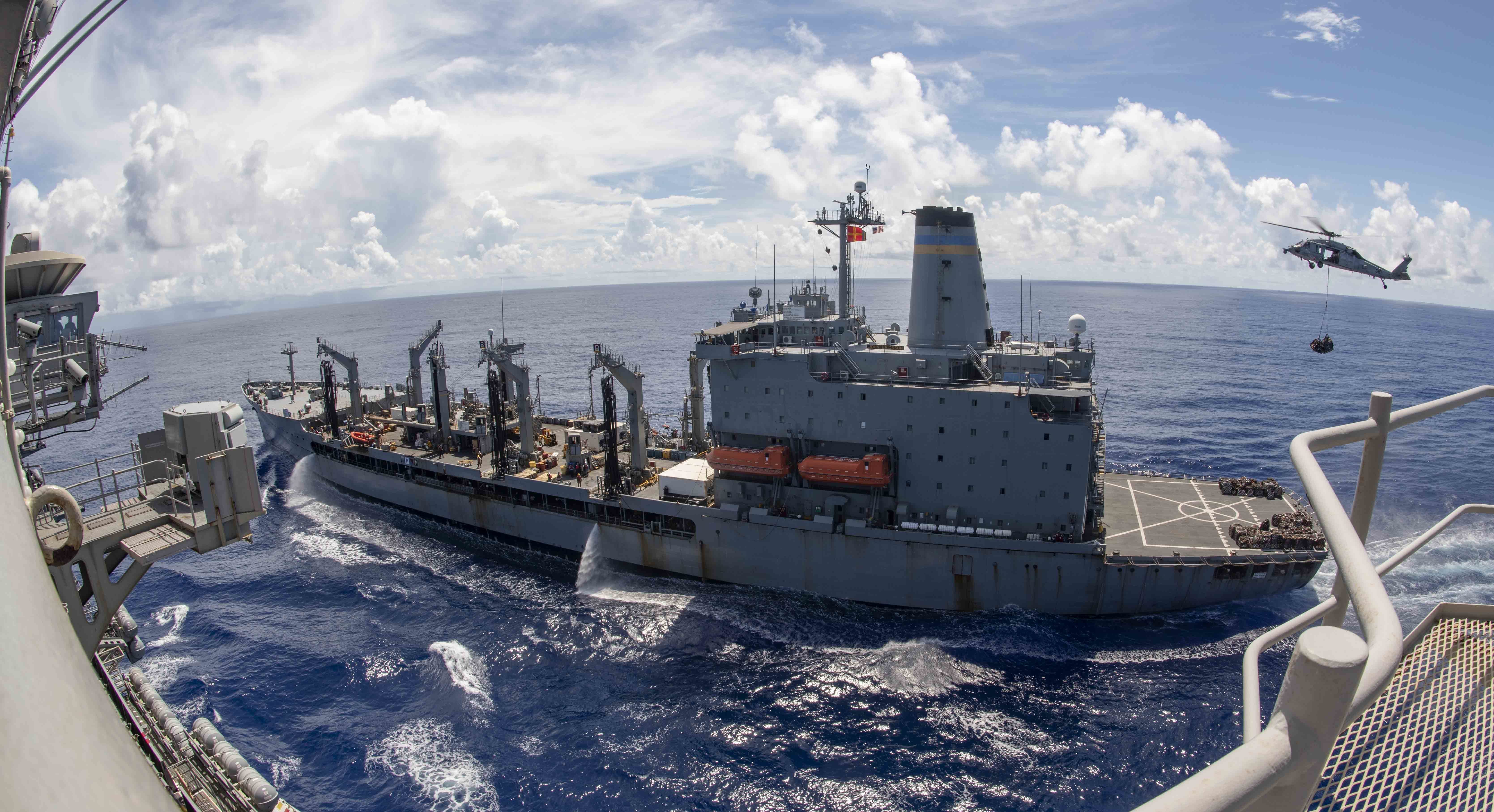 The Navy's only forward-deployed aircraft carrier USS Ronald Reagan (CVN 76) steams alongside fleet replenishment oiler USNS John Ericsson (T-AO 194) as an MH-60S Sea Hawk, attached to the "Golden Falcons" of Helicopter Sea Combat Squadron (HSC) 12, transports cargo during a replenishment-at-sea.