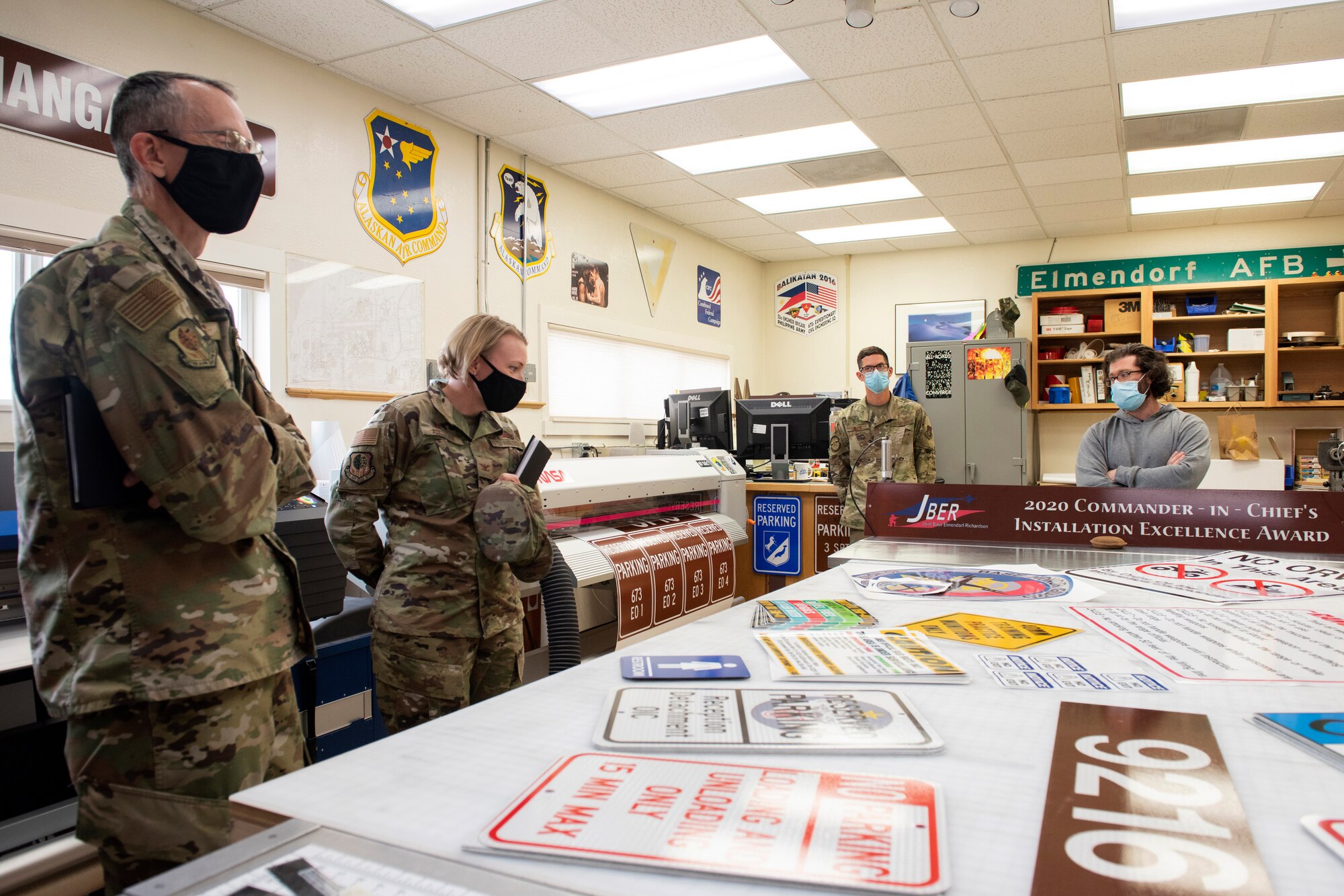 U.S. Air Force Chief Master Sgt. Lee Mills, left, Joint Base Elmendorf-Richardson and 673d Air Base Wing command chief, and U.S. Air Force Col. Kirsten Aguilar, JBER and 673d ABW commander, look at signs during a 773d Civil Engineer Squadron immersion tour at JBER, Alaska, Sept. 1, 2020. Aguilar familiarized herself with the 773d CES and its role in supporting installation readiness after taking command of the installation on July 14, 2020. The 773d CES maintains structures throughout the base as well as runs the installation’s emergency management program.