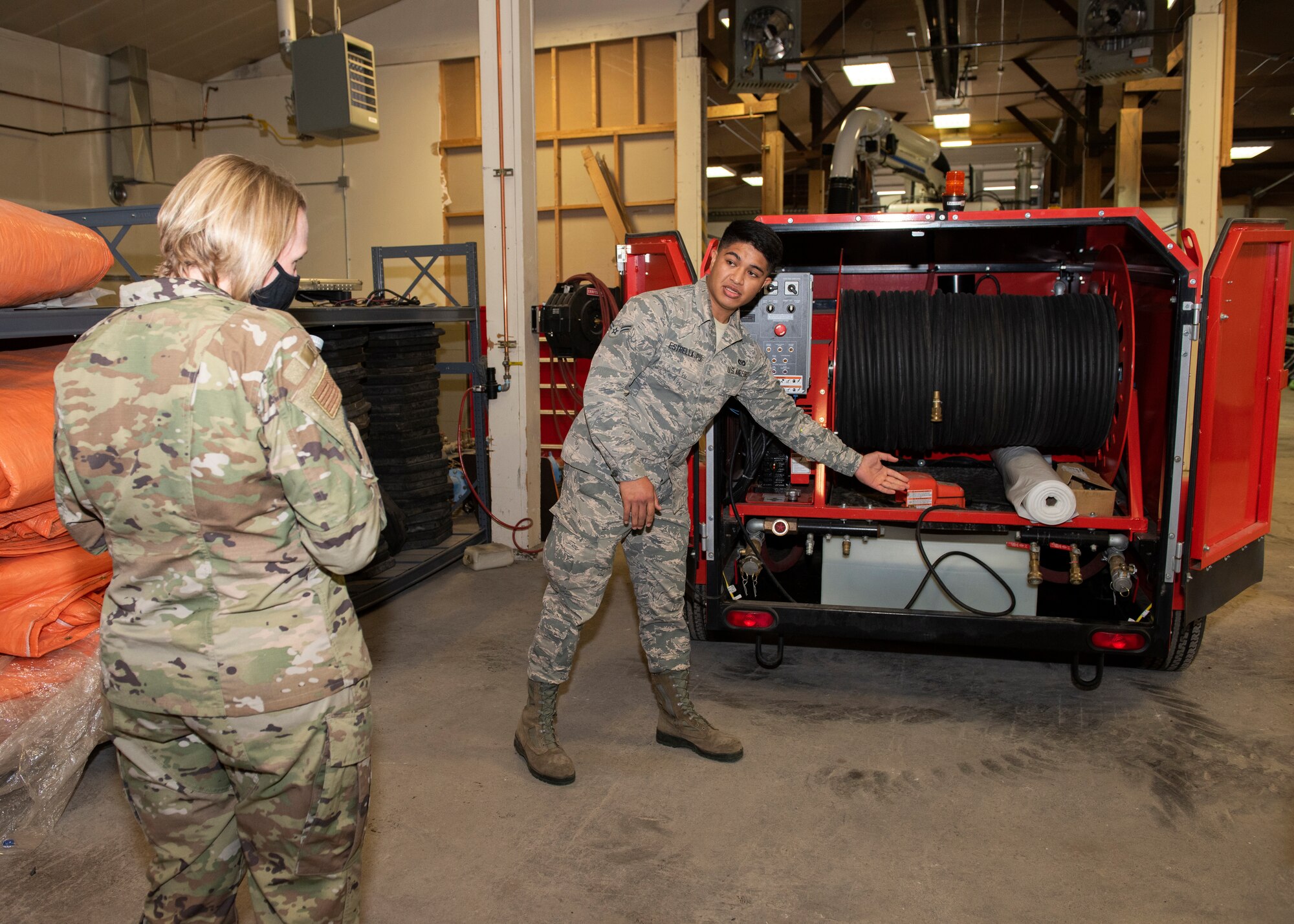 U.S. Air Force Airman 1st Class Kaleb Estrella-Pu, 773d Civil Engineer Squadron water and fuels system maintenance apprentice, briefs U.S. Air Force Col. Kirsten Aguilar, Joint Base Elmendorf-Richardson and 673d Air Base Wing commander, on thawing frozen pipes during a 773d CES immersion tour at JBER, Alaska, Sept. 1, 2020. Aguilar familiarized herself with the 773d CES and its role in supporting installation readiness after taking command of the installation on July 14, 2020. The 773d CES maintains structures throughout the base as well as runs the installation’s emergency management program.