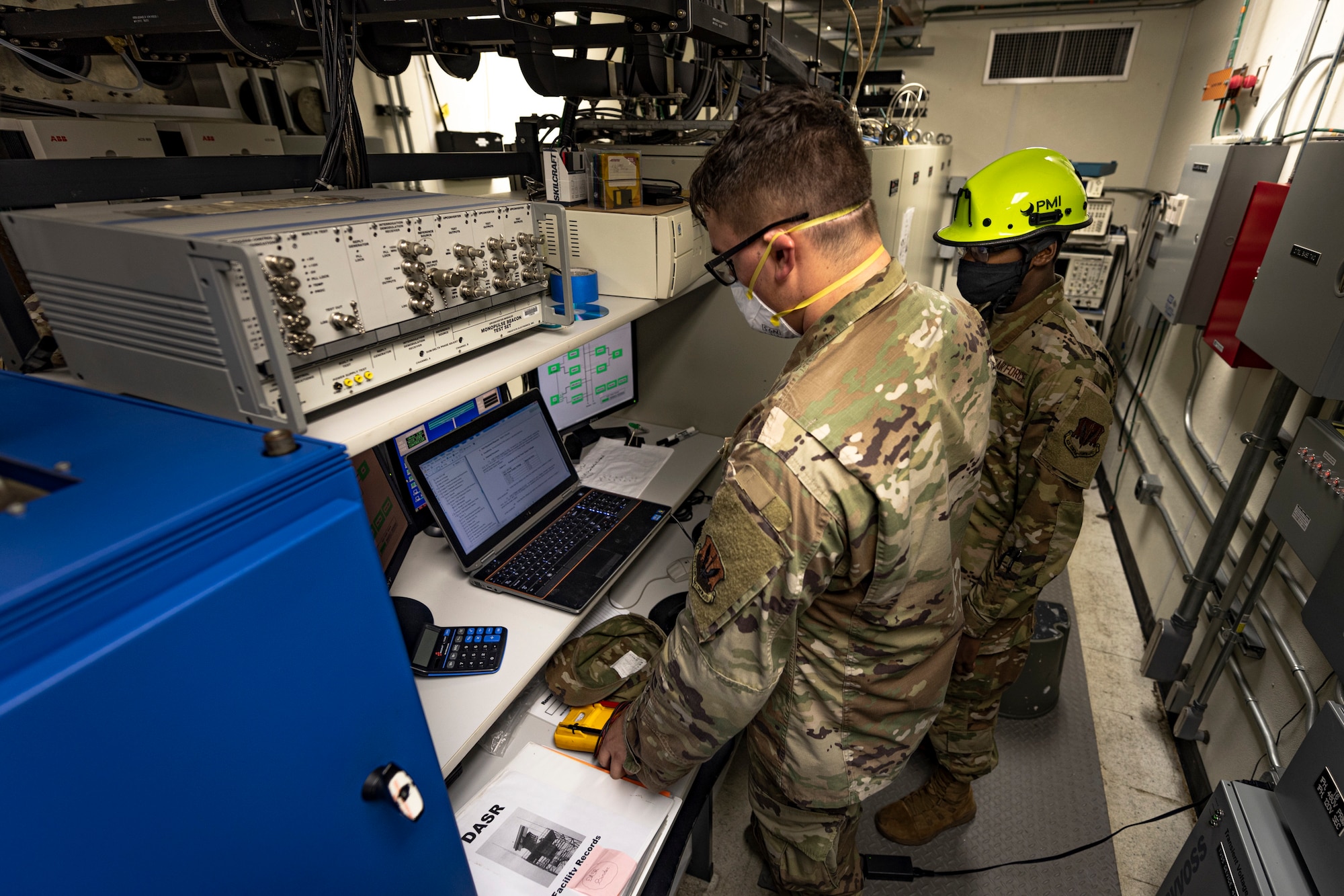 A photo of an Airman looking over technical orders