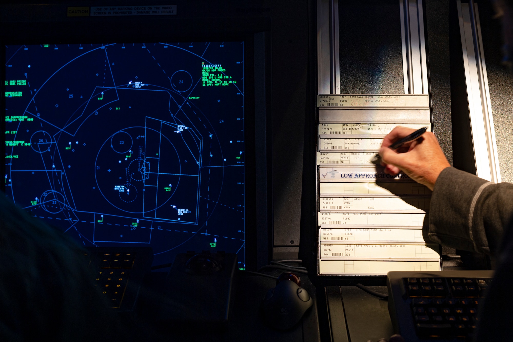 A photo of an Airman recording flight information