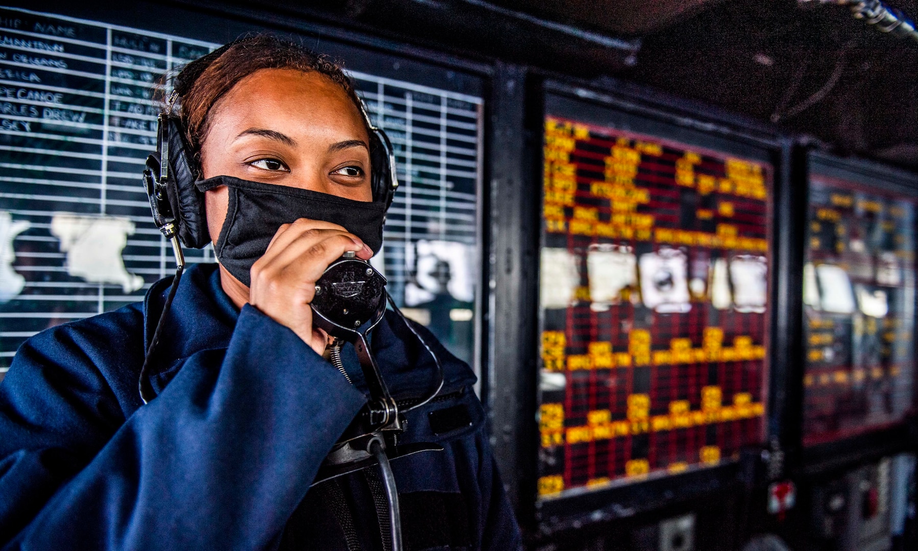 Sailor communicates with combat information center while standing watch on bridge