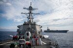 PHILIPPINE SEA (May 30, 2020) The Arleigh-burke class guided-missile destroyer USS Barry (DDG 52) conducts a replenishment at sea training evolution alongside the Nimitz class aircraft carrier USS Ronald Reagan (CVN 76). Barry is forward-deployed to the U.S. 7th Fleet area of operations in support of security and stability in the Indo-Pacific region. (U.S. Navy photo by Ltjg. Samuel Hardgrove)