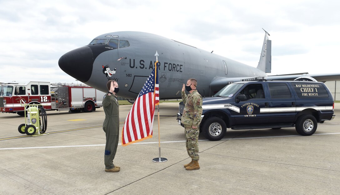 Capt. Anthony Caliva, left, 351st Air Refueling Squadron pilot, reenlists Chief Master Sgt. Travis Clawson, 100th Civil Engineer Squadron installation fire chief, at Royal Air Force Mildenhall, England, Sept. 2, 2020. Clawson was previously an instructor at the U.S. Air Force Academy in Colorado Springs, Colo., and was the recipient of Caliva’s “silver dollar salute” in 2012. (U.S. Air Force photo by Karen Abeyasekere)