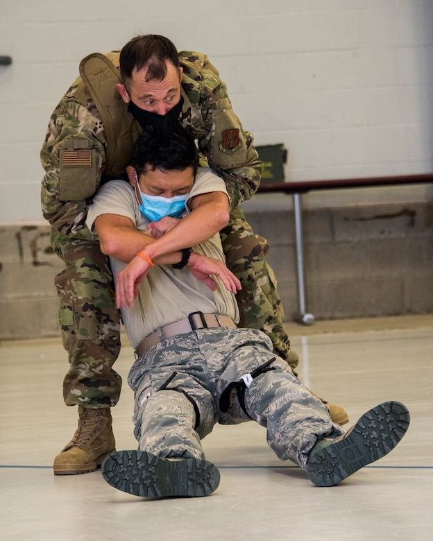 Master Sgt. Joseph Dwulit drags Technical Sgt. Chemmeng Low during a Tactical Combat Casualty Care practical evaluation