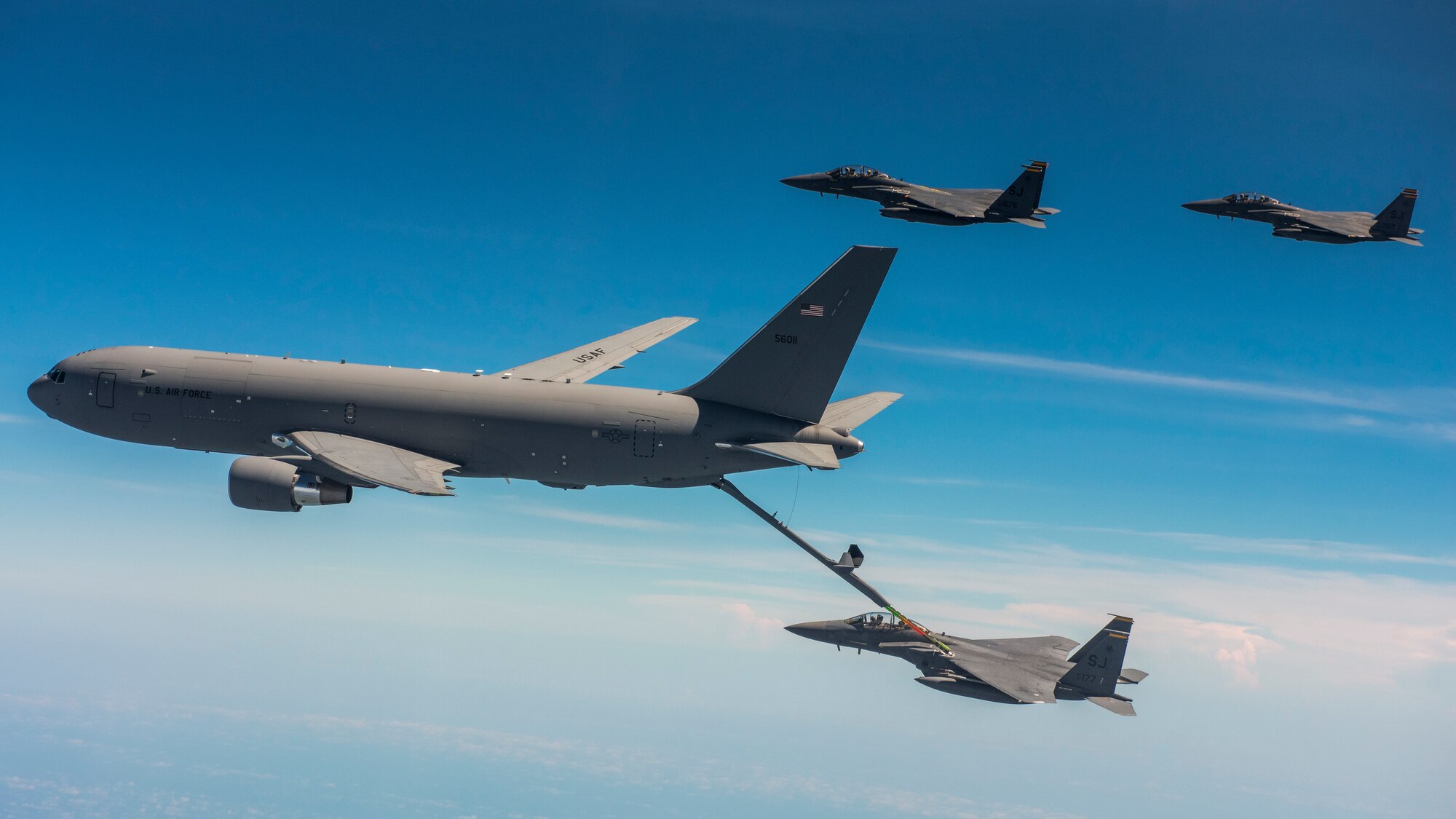 A KC-46 Pegasus from the 916th Air Refueling Wing in-air refuels F-15E Strike Eagles from the 336th Fighter Squadron at Seymour Johnson Air Force Base over the sky of North Carolina.