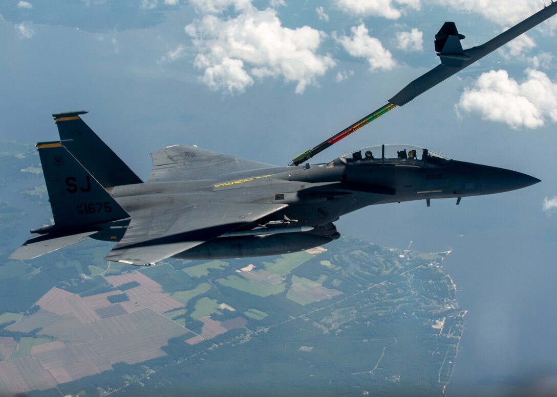An F-15E Strike Eagle from the 336th Fighter Squadron at Seymour Johnson Air Force Base is in-air refueled by a KC-46 Pegasus from the 916th Air Refueling Wing in the sky over North Carolina.