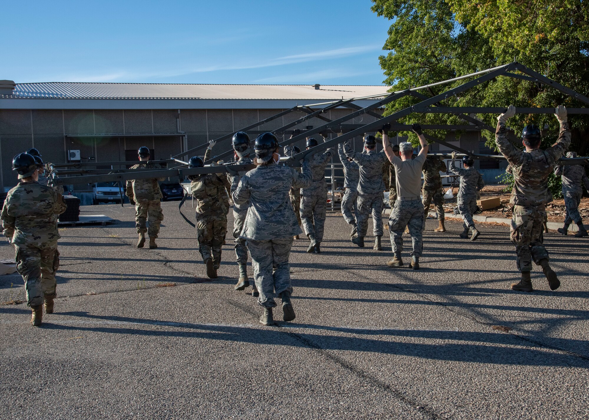 Airmen from the 366th Force Support Squadron move a tent base during a training exercise, Sept. 4, 2020, on Mountain Home Air Force Base, Idaho. The training is part of an annual pallet expeditionary kitchen set up exercise. (U.S. Air Force photo by Airman Andrea Rozoto)