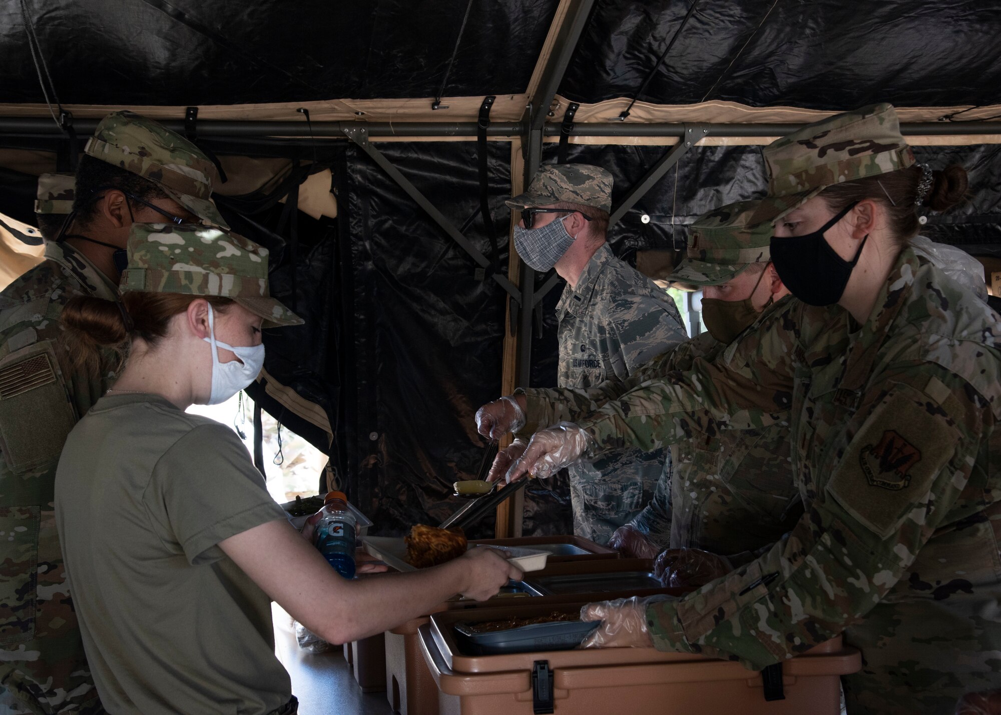 Airmen from the 366th Force Support Squadron are served part of a Unitized Group Ration during a training exercise, Sept. 4, 2020, on Mountain Home Air Force Base, Idaho. The training is part of an annual pallet expeditionary kitchen set up exercise. (U.S. Air Force photo by Airman Andrea Rozoto)