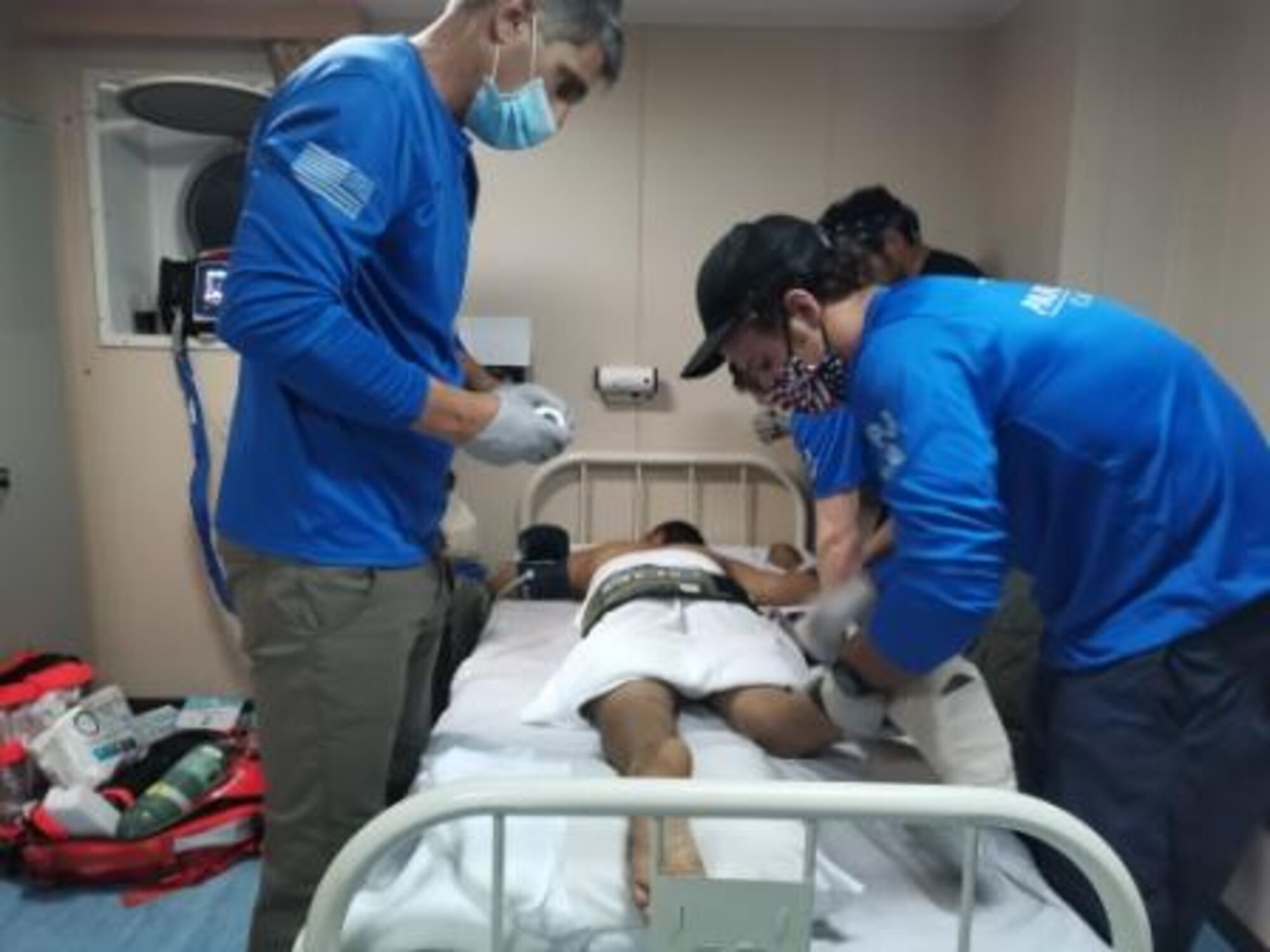 Medical professionals evaluate an injured Chinese sailor Aug. 27, 2020.