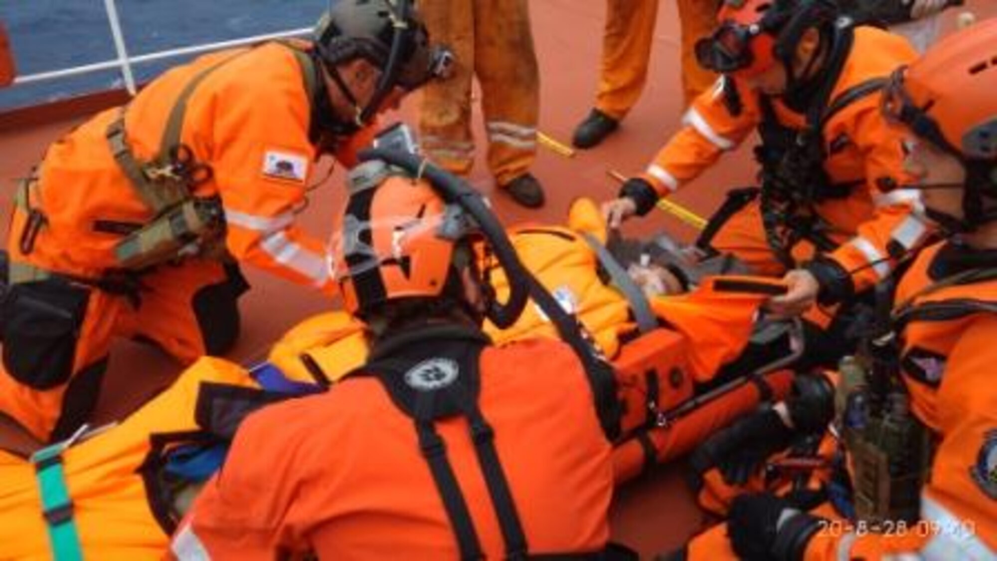 The U.S. Coast Guard Search & Rescue team from Alameda, California, prepare an injured sailor to be lifted to an Air Force helicopter, Aug. 27, 2020, off the coast of California.