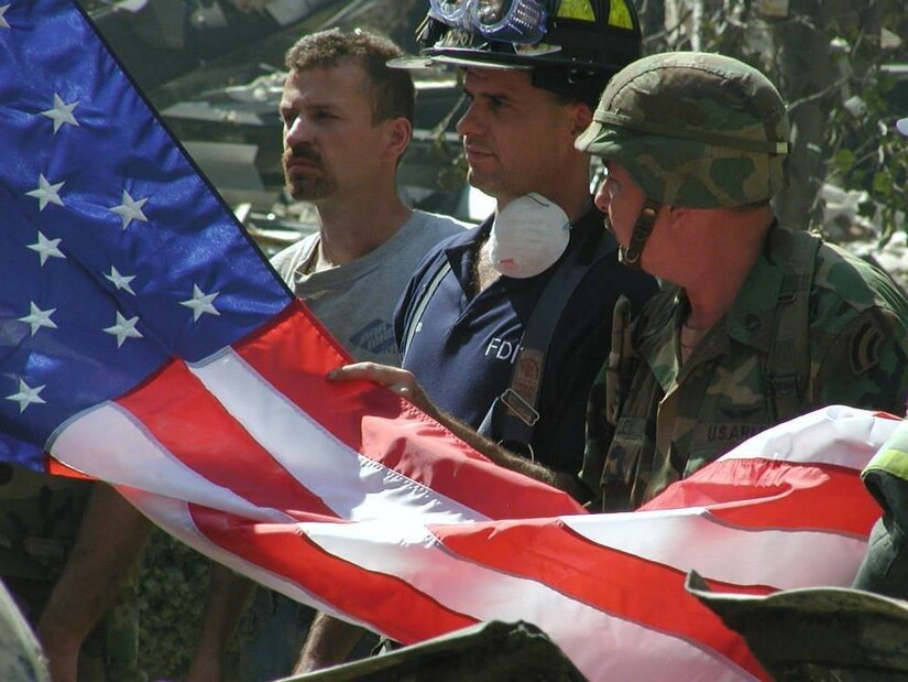 Soldiers from the New York Army National Guard fold a flag in front of ground zero. 19 years have passed since the deadliest terrorist attack on American soil, and four Soldiers from the New York Army National Guard reminisce about their experiences from ground zero.( Photo by Lt. Col. Gurpreet Singh)