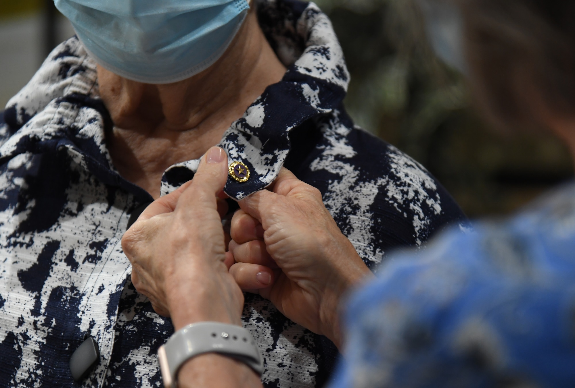 Karen McGill, Gold Star Family Member, pins a Gold Star Family Member lapel pin on the shirt of her mother, Myrna Cody, Gold Star Family Member, inside Cody Hall at Keesler Air Force Base, Mississippi, Sept. 2, 2020. Myrna Cody's husband, U.S. Air Force Capt. Howard Cody, was a senior pilot who was killed in action in South Vietnam in 1963. (U.S. Air Force photo by Kemberly Groue)