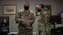 Senior Master Sgt. Haney looks over a report with Master Sgt. Rebekah Schroeder at Joint Base Langley-Eustis, Virginia, July 22, 2020.