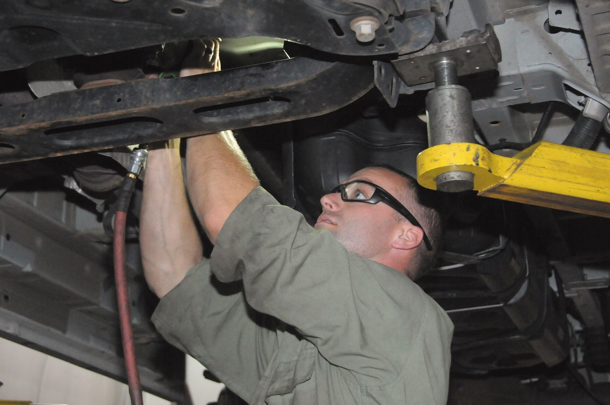 Tech. Sgt. Taylor Harnist, vehicle maintenance journeyman with the 445th Logistics Readiness Squadron, repairs a vehicle at Germain Ford of Beavercreek. Germain Ford established a program with LRS to provide hands-on training to LRS Airmen.