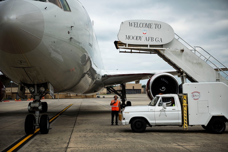 Photo of Airmen preparing to offload passengers.