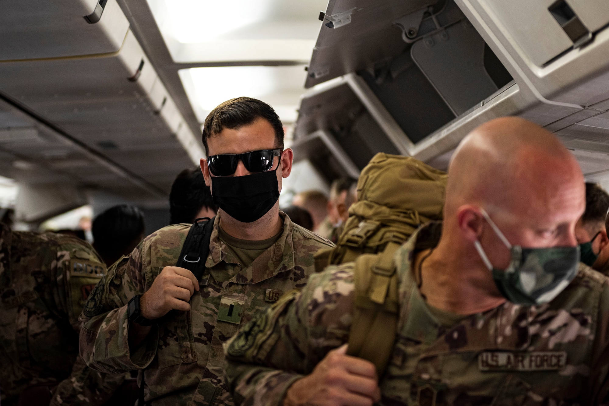 Photo of Airmen preparing to exit an aircraft.
