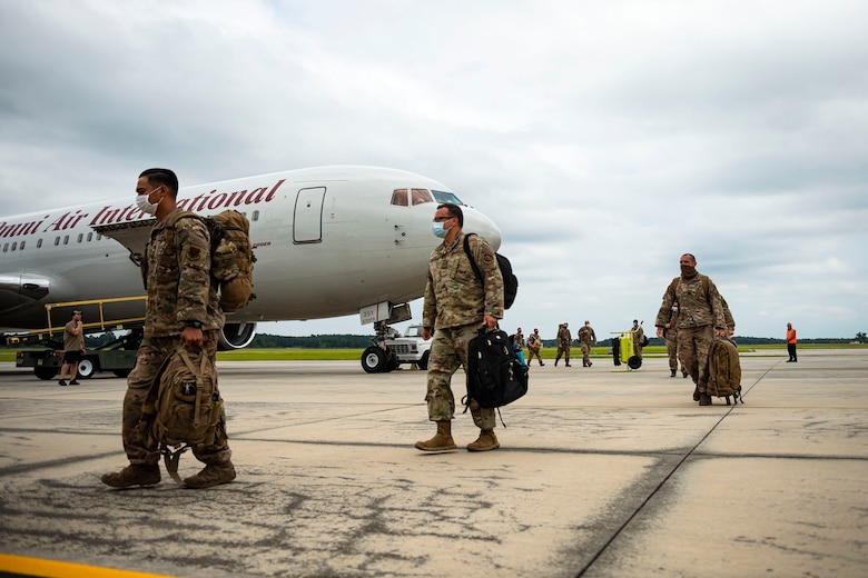 Photo of Airmen exiting an aircraft.