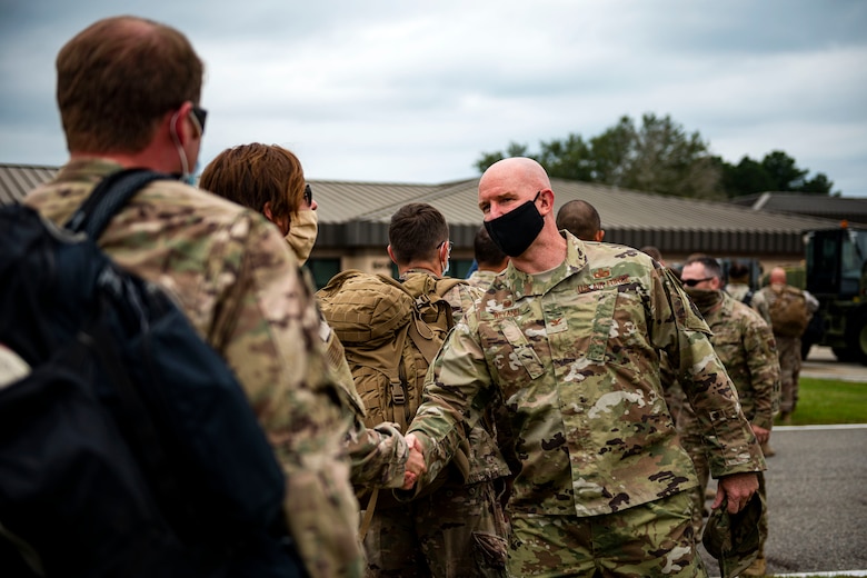 Photo of commander welcoming back Airmen.