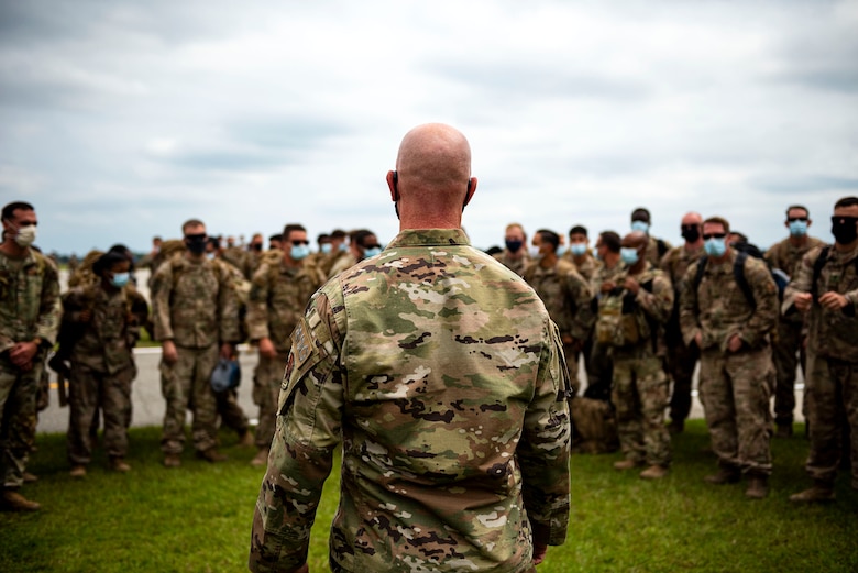 Photo of commander speaking with Airmen.