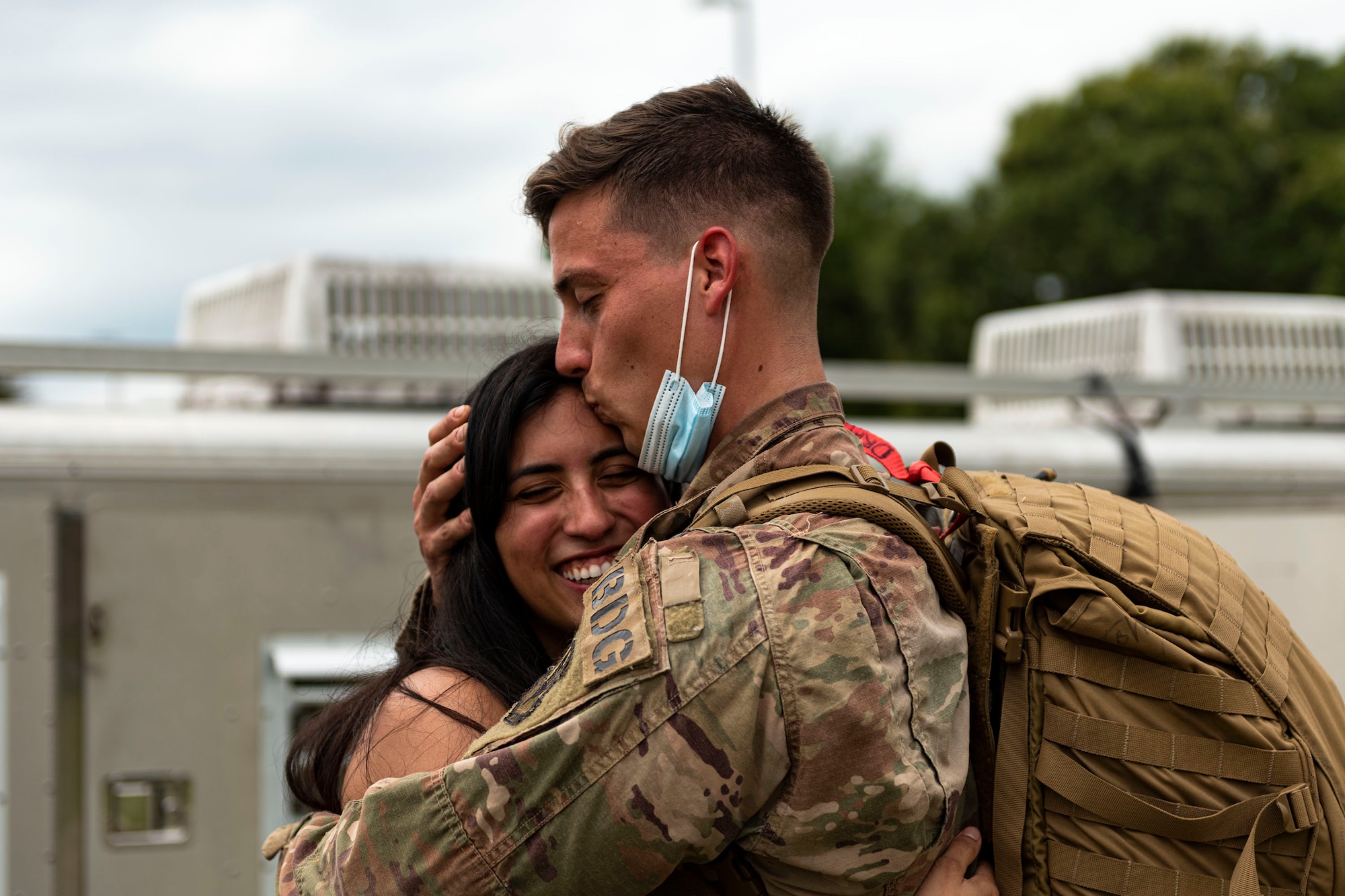 Photo of Airman kissing his wife.