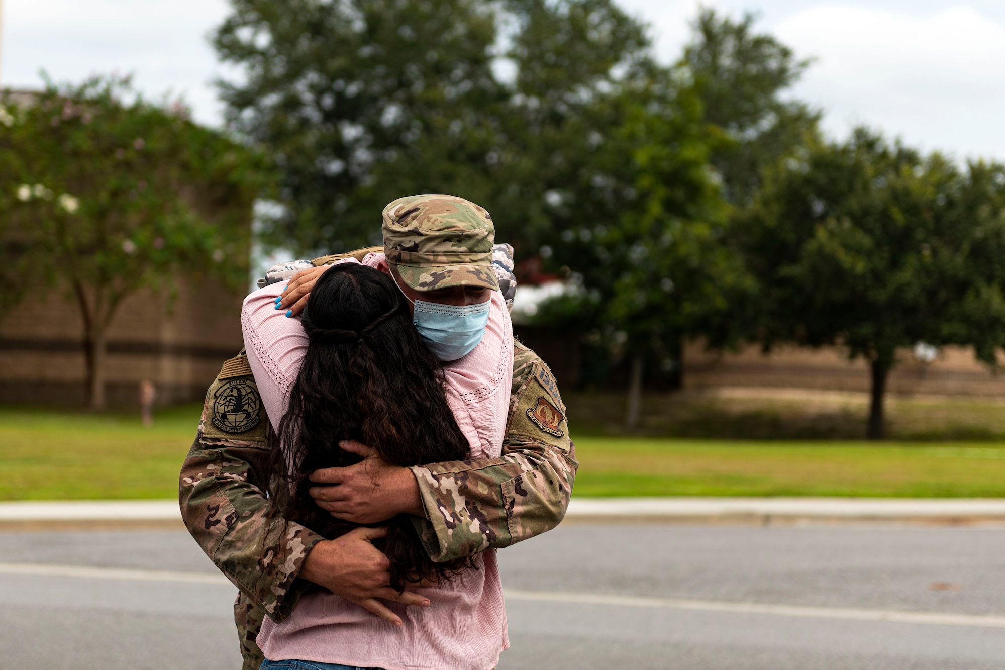 Photo of Airman hugging his wife.