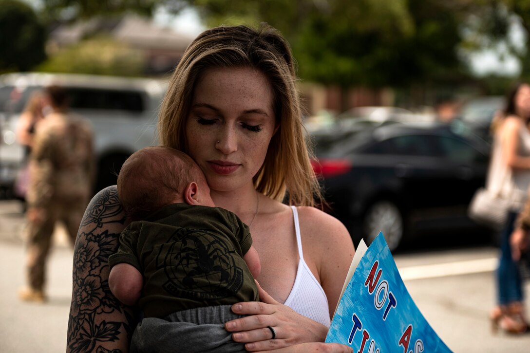 Photo of Airman holding their baby.