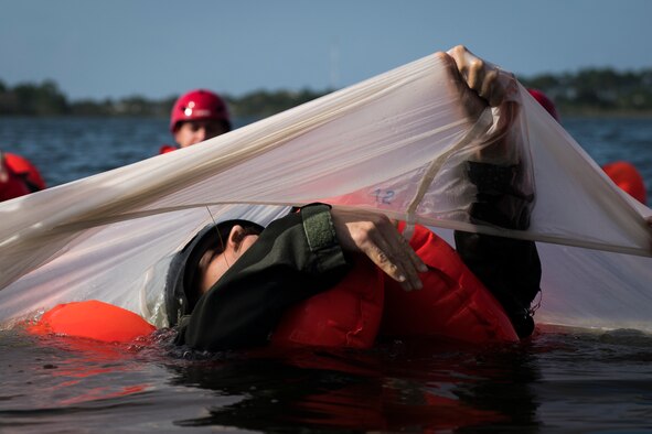 U.S. Air Force Tech. Sgt. Allen McClure, an aerial gunner instructor with the 492nd Special Operations Training Support Squadron, conducts canopy disentanglement during parachuting and water survival training at Hurlburt Field, Florida, Sept. 1, 2020. Aircrew members must conduct parachuting and water survival training every three years, ensuring combat readiness to conduct operations any time, any place. (U.S. Air Force photo by Staff Sgt. Joseph Pick)