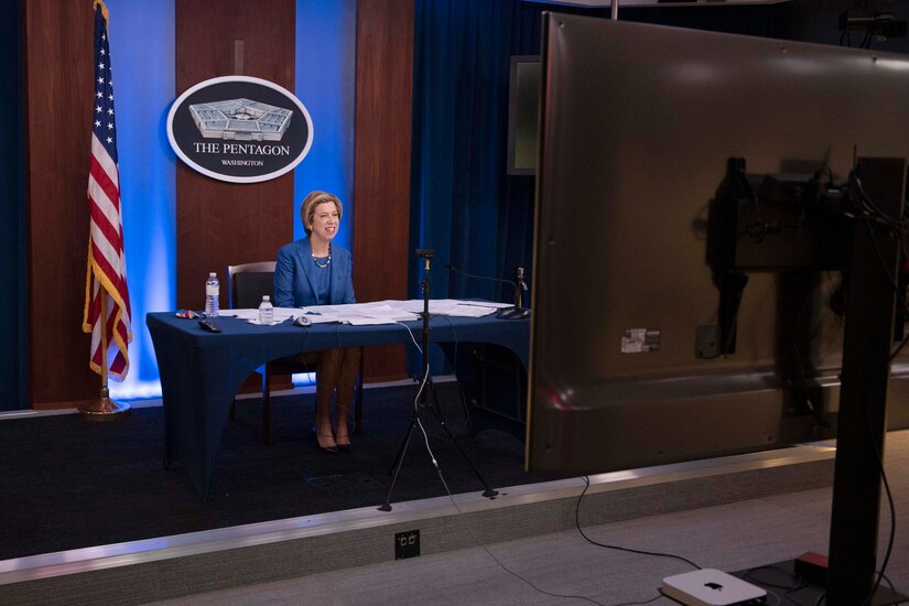 A woman sits at a table.