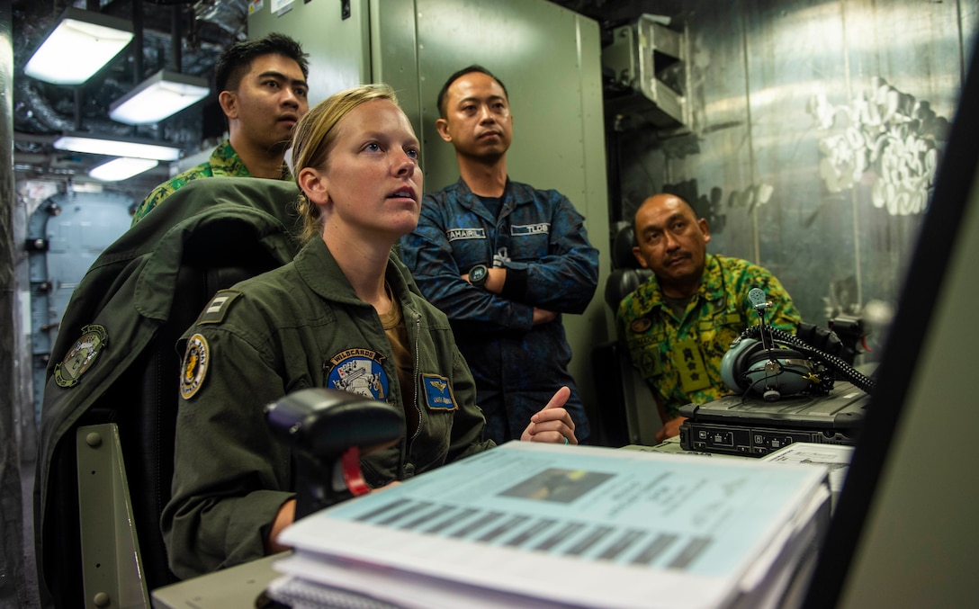 Lieutenant Laura Burzenski, assigned to “Wildcards” of Helicopter Sea Combat Squadron 23, demonstrates unmanned aerial vehicle MQ-8B Fire Scout capabilities and configurations with Royal Brunei armed forces during Cooperation Afloat Readiness and Training Brunei, South China Sea, October 30,
2019 (U.S. Navy/Christopher A. Veloicaza)