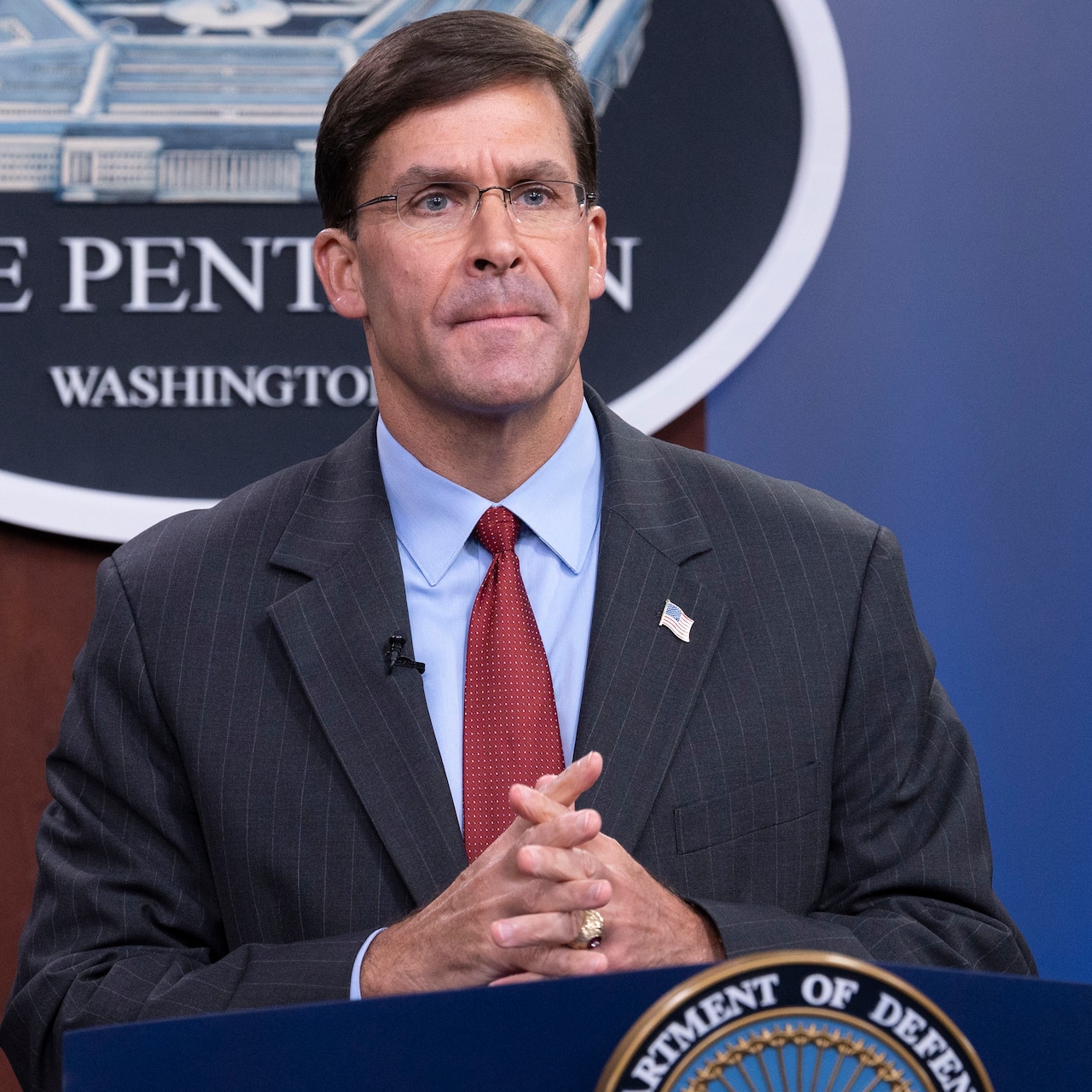 A man stands at lectern.