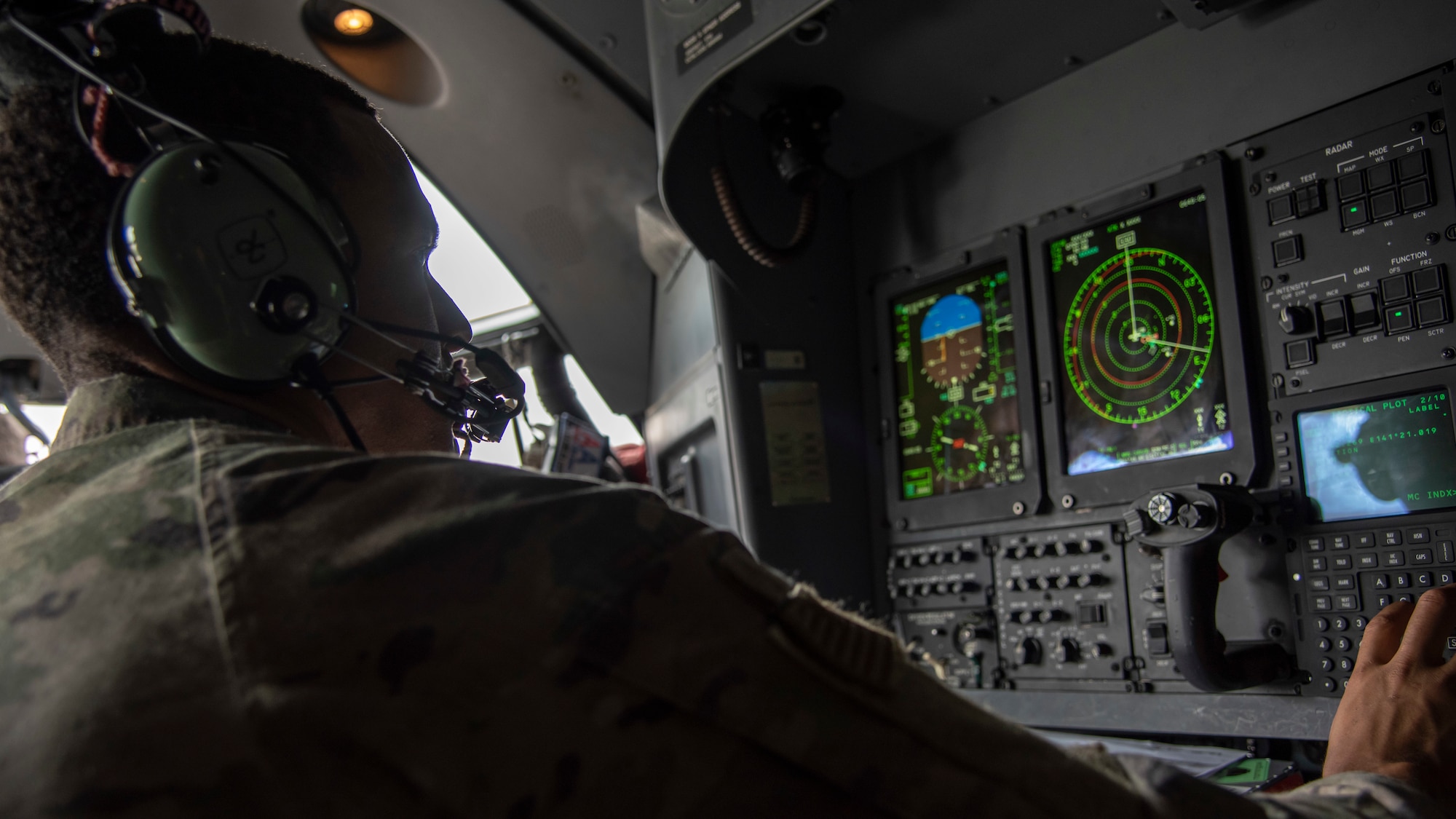 A combat systems officer assigned to the 1st Special Operations Squadron navigates off the Northern Coast of Japan, Aug. 5, 2020, during Exercise Gryphon Jet 10. Gryphon Jet is an integrated training exercise focused on improving interoperability throughout the special operations community. During this exercise formation departure, ship based air traffic control procedures, night vision goggle mountain low level, air intercepts with F/A-18s and tilt-rotor air-to-air refueling with the CV-22 were simulated. (U.S. Air Force photo by Airman 1st Class China M. Shock)