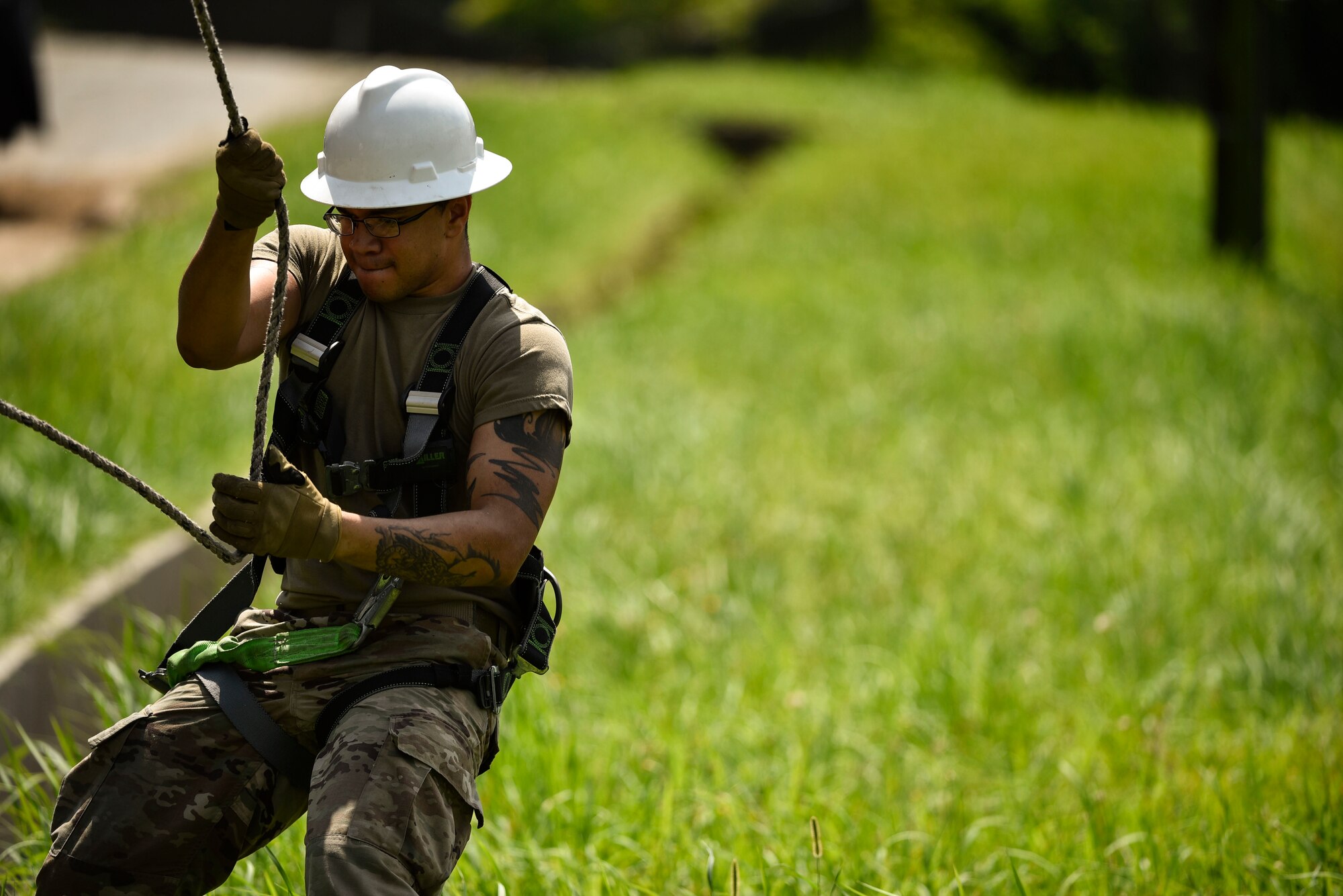 Staff Sgt. Bobby Breland, 8th Civil Engineer Squadron heavy equipment and pavement craftsman, assists in reattaching a line during typhoon recovery operations at Kunsan Air Base, Republic of Korea, Sept. 3, 2020.