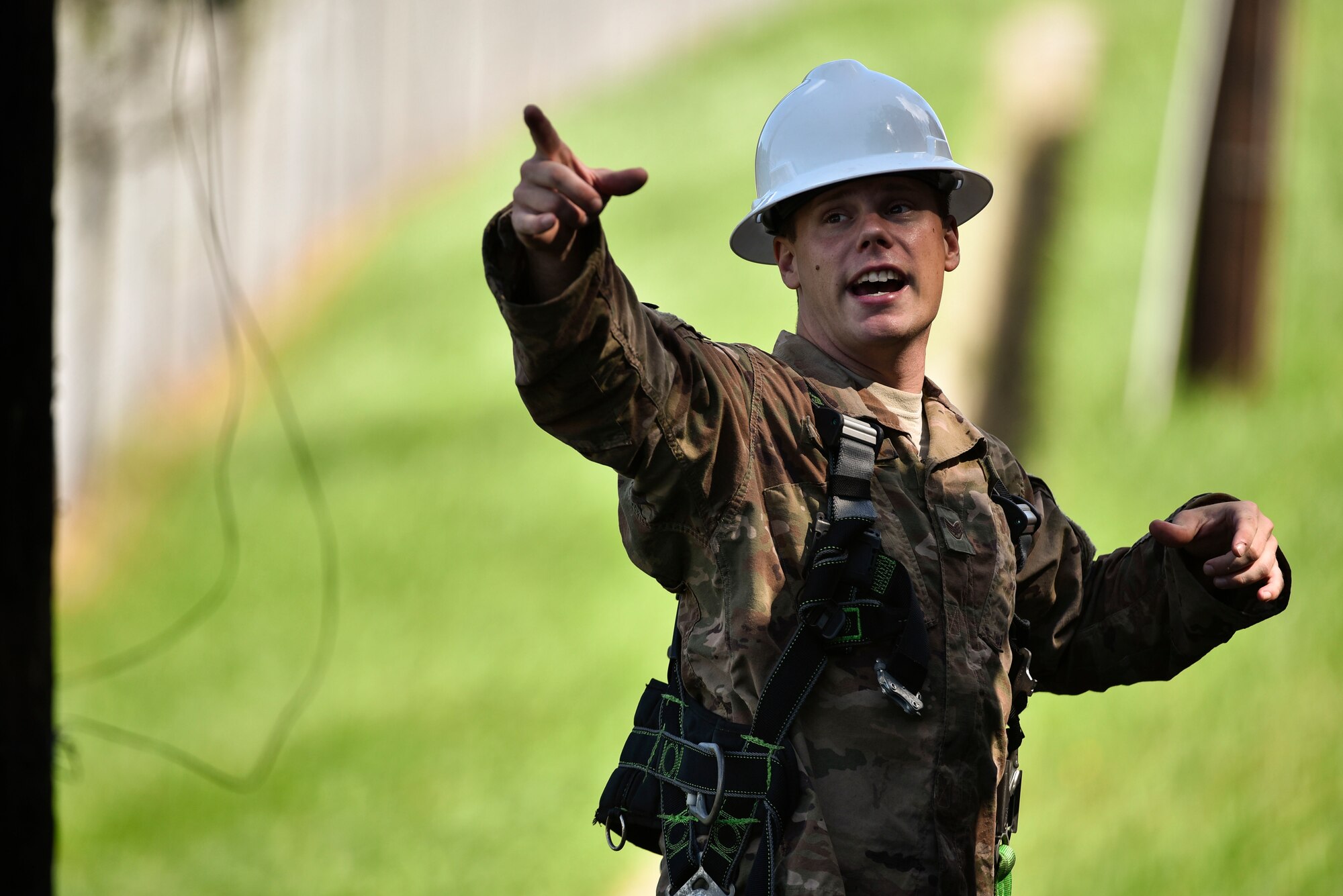 Staff Sgt. Mark Sylvester, 8th Civil Engineer Squadron electrical systems technician, communicates to another CES Airman during typhoon recovery operations at Kunsan Air Base, Republic of Korea, Sept. 3, 2020.