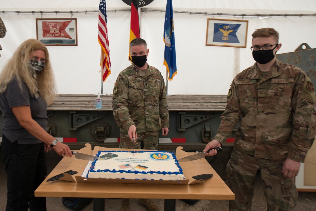 A photo of a cake cutting ceremony