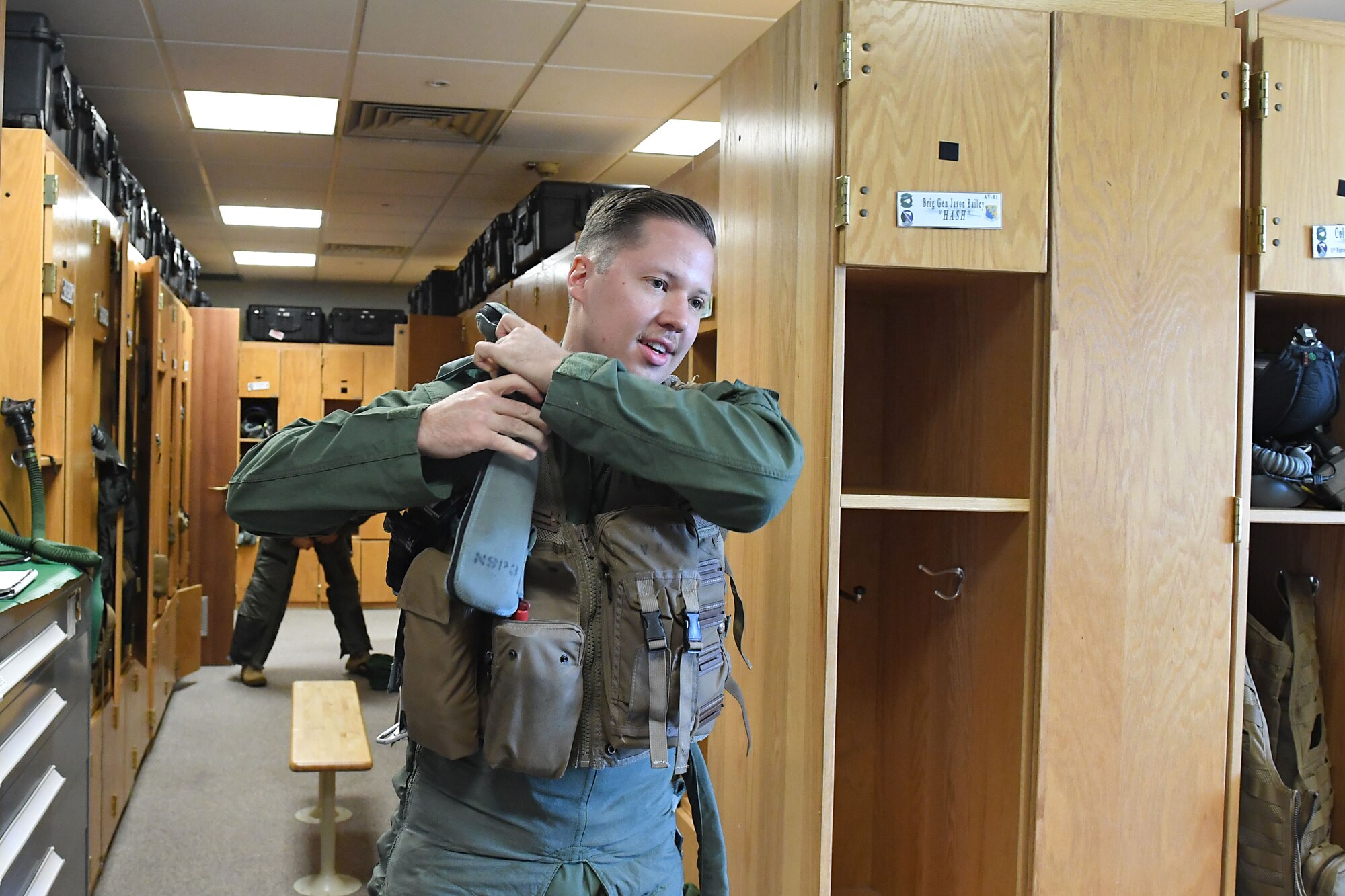 U.S. Air Force Staff Sgt. Devon Kercher, 31st Operations Support Squadron Radar Approach Control senior watch supervisor, dons flight gear before a familiarization flight at Aviano Air Base, Italy, Sept. 3, 2020. Kercher was recently recognized as the 2019 U.S. Air Forces in Europe Air Traffic Controller of the Year. (U.S. Air Force photo by Staff Sgt. Valerie Halbert)