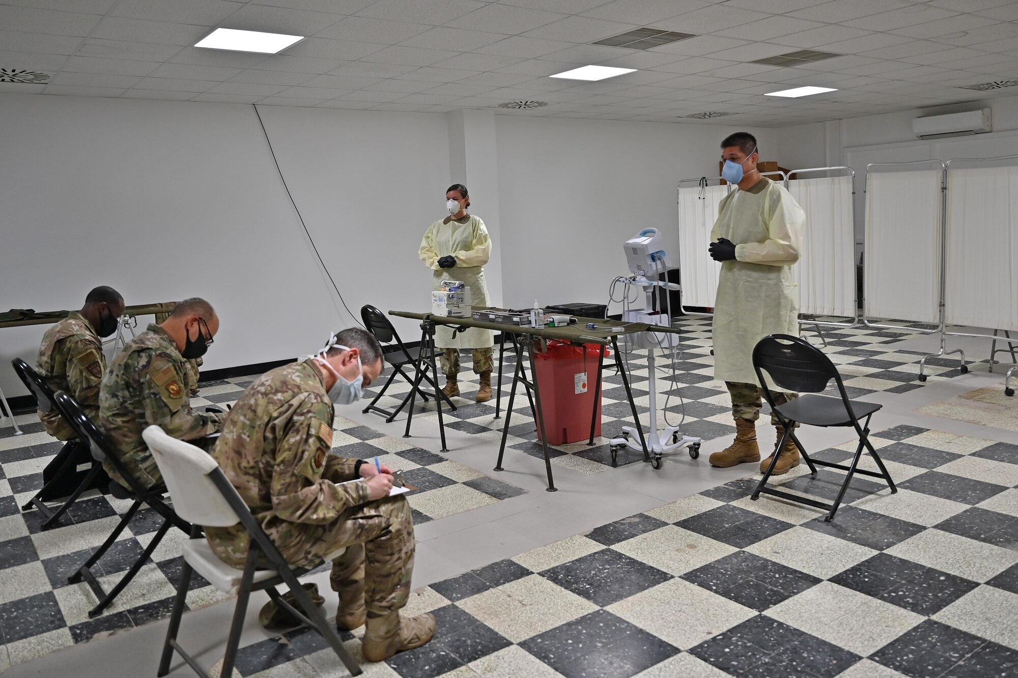 U.S. Air Force Gen. Jeffrey L. Harrigian, U.S. Air Forces in Europe and Air Forces Africa commander, Brig. Gen. Ronald E. Jolly, USAFE-AFAFRICA engineering and force protection director of logistics, and Chief Master Sgt. Brion Blais, USAFE-AFAFRICA command chief, fill out expeditionary medical screening paperwork after arriving at Camp Lemonnier, Djibouti, September 1, 2020. USAFE-AFAFRICA leadership visited Airmen from around the 449th Air Expeditionary Group deployed throughout Africa to see the mission first hand and show appreciation for the Airmen stationed down range. (U.S. Air Force photo by Staff Sgt. Dana J. Cable)