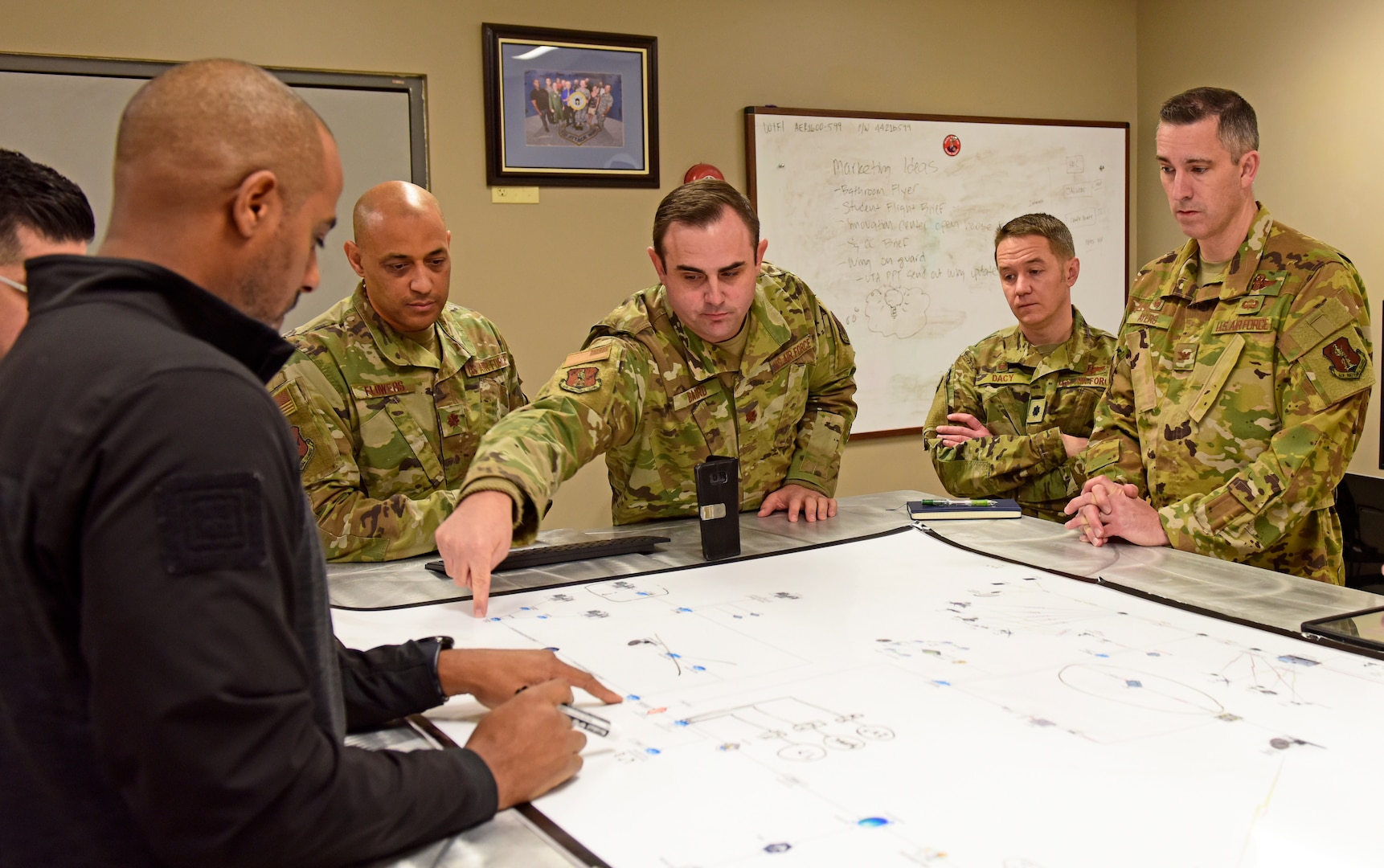 The Air Force nomination of the 163d Attack Wing's Hap Arnold Innovation Center (HAIC) recognizes, among other criteria, "replication of the innovation across the Air Force enterprise." Here, left to right, Alion program manager Doug Witherspoon, HAIC director Maj. Jason Flowers, and senior adviser to the director Lt. Col. Michael Baird share best practices with Lt. Col. Kevin Dacy and Col. Ryan Ayers, part of an MQ-9 Reaper team from the 119th Wing in Fargo, North Dakota, that visited the center in December 2019.