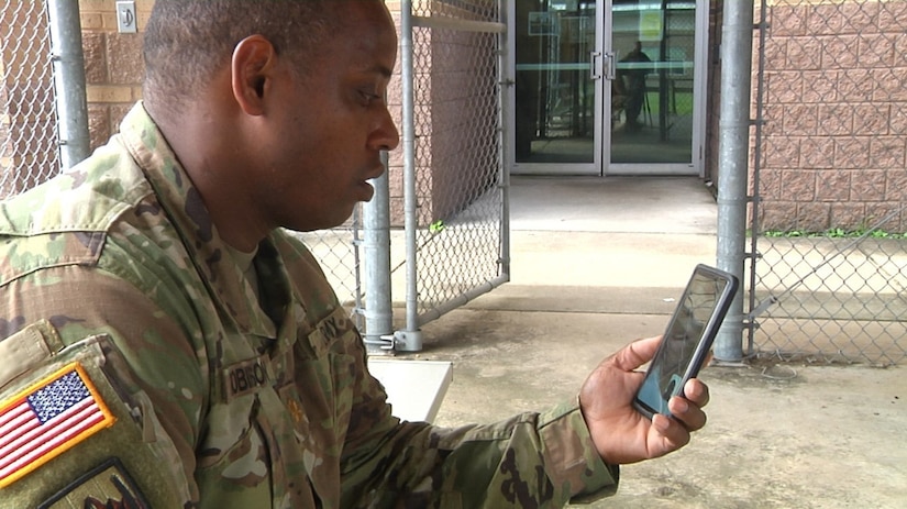 Maj. Henry Robinson, Jr., the senior mobility officer for the 377th Theater Sustainment Command, calls home to his family on a video call during a lunch break at the headquarters building in Belle Chasse, La., Sept. 2, 2020.