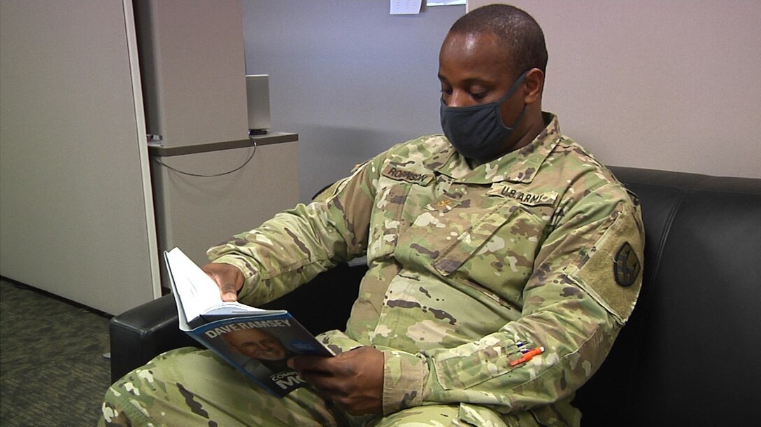 Maj. Henry Robinson, Jr., the senior mobility officer at the 377th Theater Sustainment Command, takes a moment to read a book during his downtime at the headquarters building in Belle Chasse, La., Sept. 2, 2020.