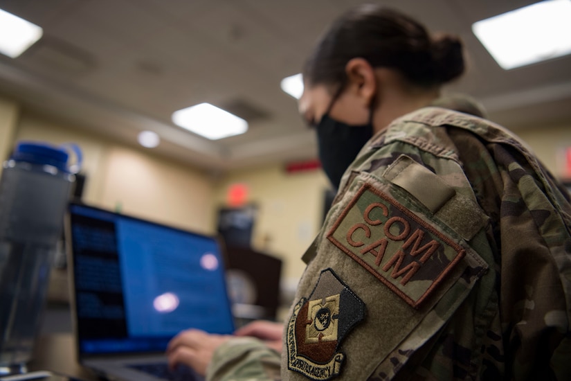 A Woman works on a computer.