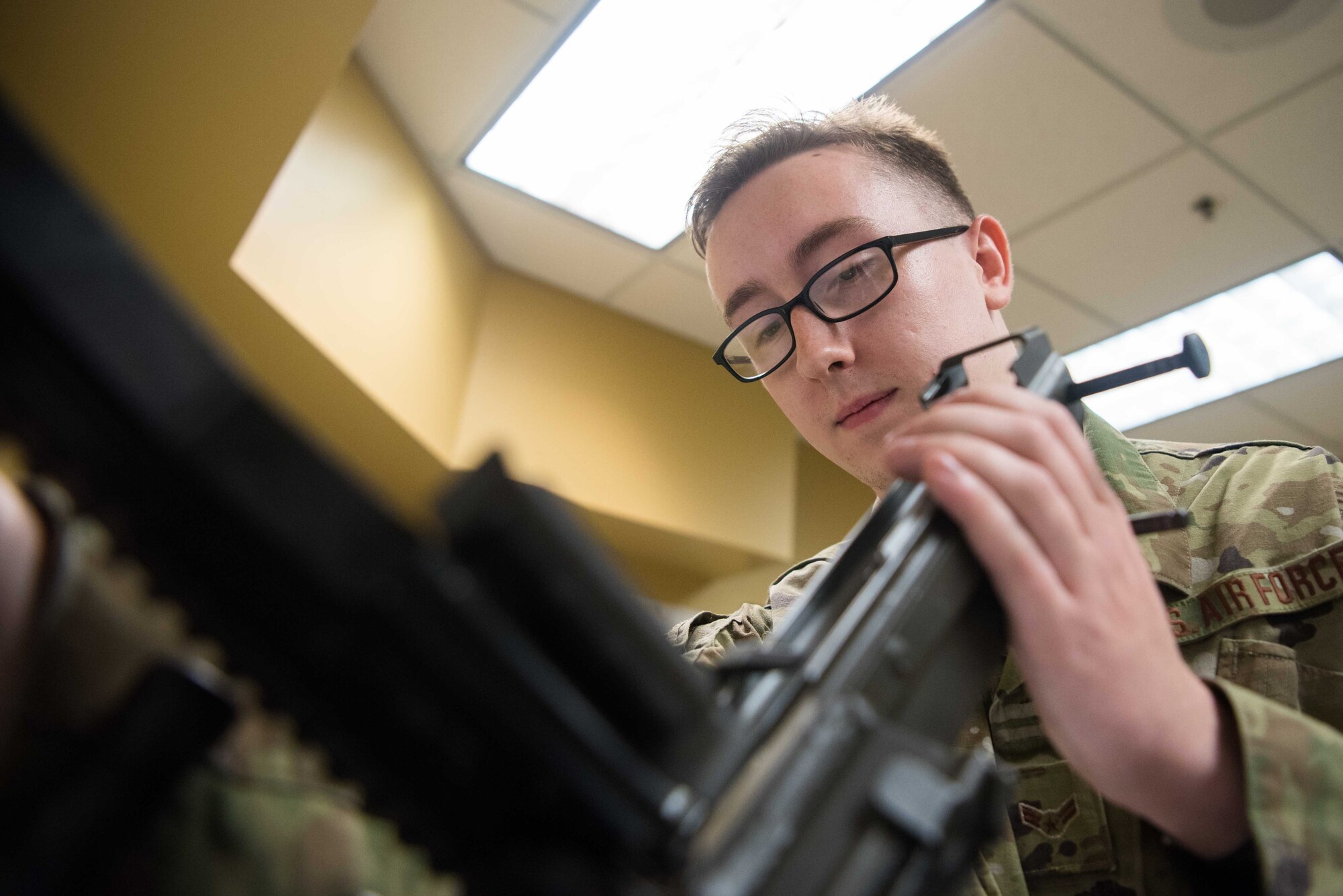 Airman 1st Class Brandon Holland, 22nd Security Forces Squadron armorer, performs a function check on an M249 light machine gun Sept. 8, 2020, at McConnell Air Force Base, Kansas. Function checks must be performed at minimum once a month on each weapon to ensure all the equipment is working properly and that no malfunctions will occur while on duty. (U.S. Air Force photo by Senior Airman Alexi Bosarge)