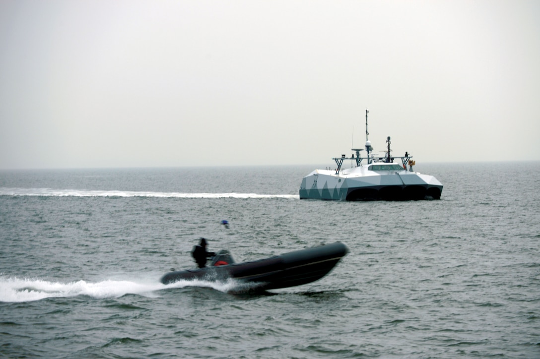 Simulated small boat threats pass by high-speed experimental boat Stiletto so Sailors assigned to Navy Expeditionary Combat Command can observe new technologies in relevant maritime environment, Atlantic Ocean, January 16, 2013 (U.S. Navy)