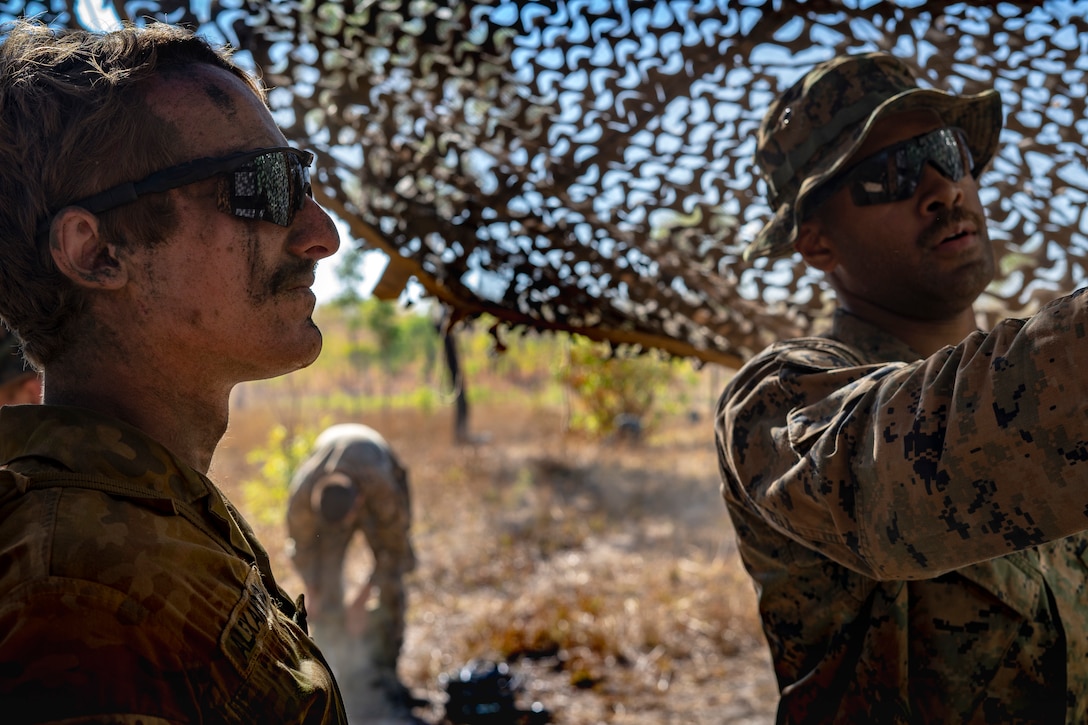 A U.S. Marine and Australian Defence Force Army Capt. discuss the scheme and manuever for 5th Battalion, Royal Australian Regiment fire and attacks, as well as procedures at each others' respective combat operations centers during Exercise Koolendong at Mount Bundey Training Area, Northern Territory, Australia, Sept. 6.