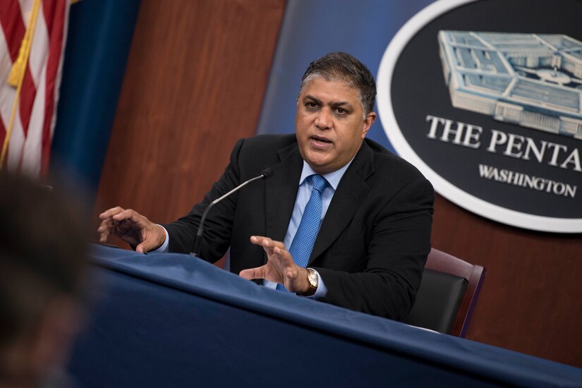 A man sits in front of a microphone.