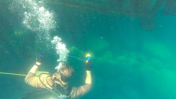 Explosive Ordnance Disposal Technician 2nd Class Brendan Owen, assigned to Commander, Task Force 56, conducts a anti-terrorism force protection (ATFP) dive during training with members of the Royal Jordanian Navy during Exercise Infinite Defender 2020 (ID 20) at the Royal Jordanian Naval Base in Aqaba, Jordan.